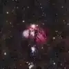 a cluster of stars in the middle of a night sky