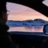 a man driving a car on a snowy road